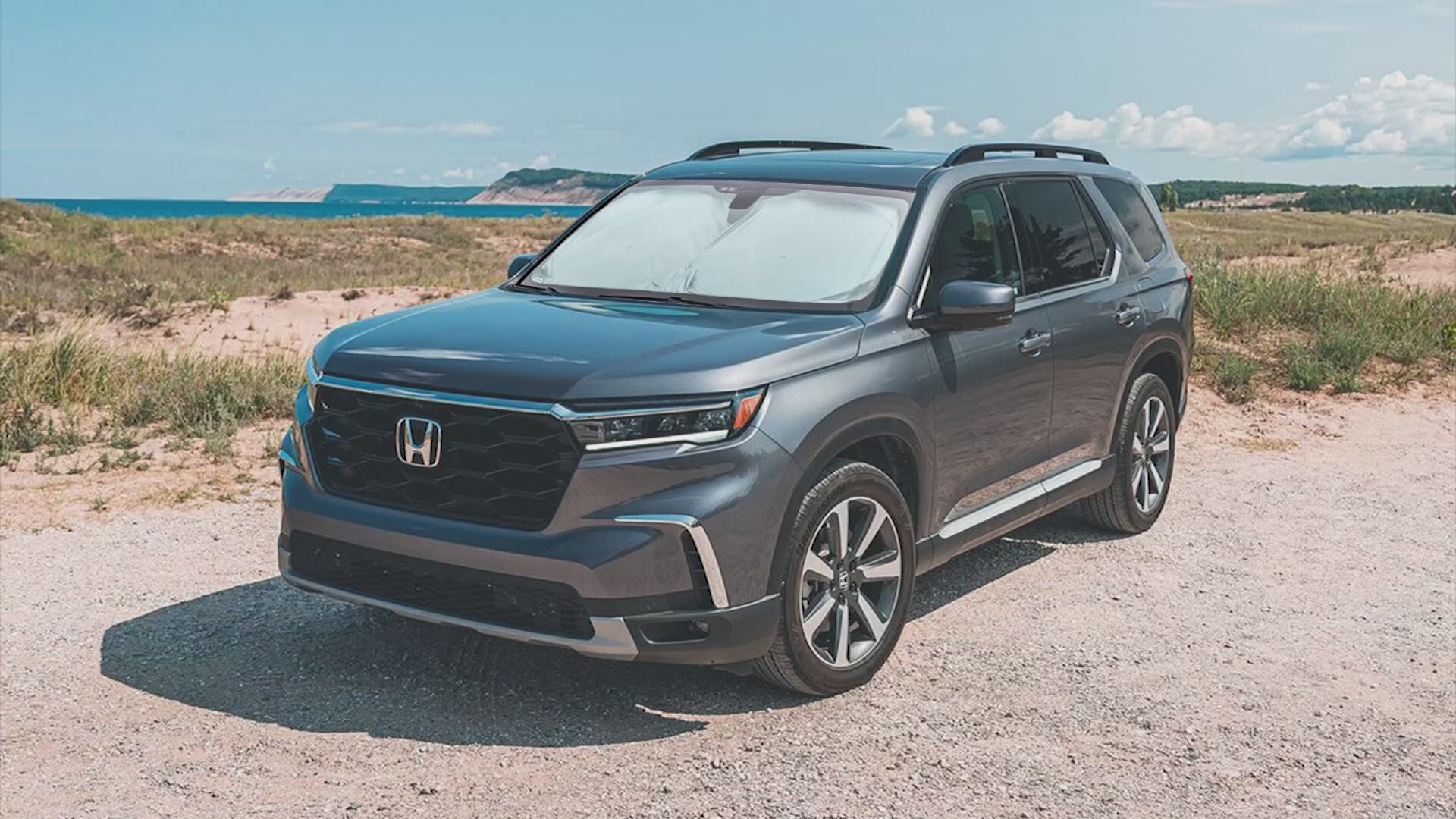 Windshield sun shade for Honda Pilot 2016-2025, foldable SUV window sun visor protector, blocks UV rays, keeps car interior cooler, front windshield sunshade for Honda Pilot, heat reducing sun blocker, automotive sun protection accessory, vehicle sun visor cover, foldable sun shield for SUV, car sunshade for Honda Pilot